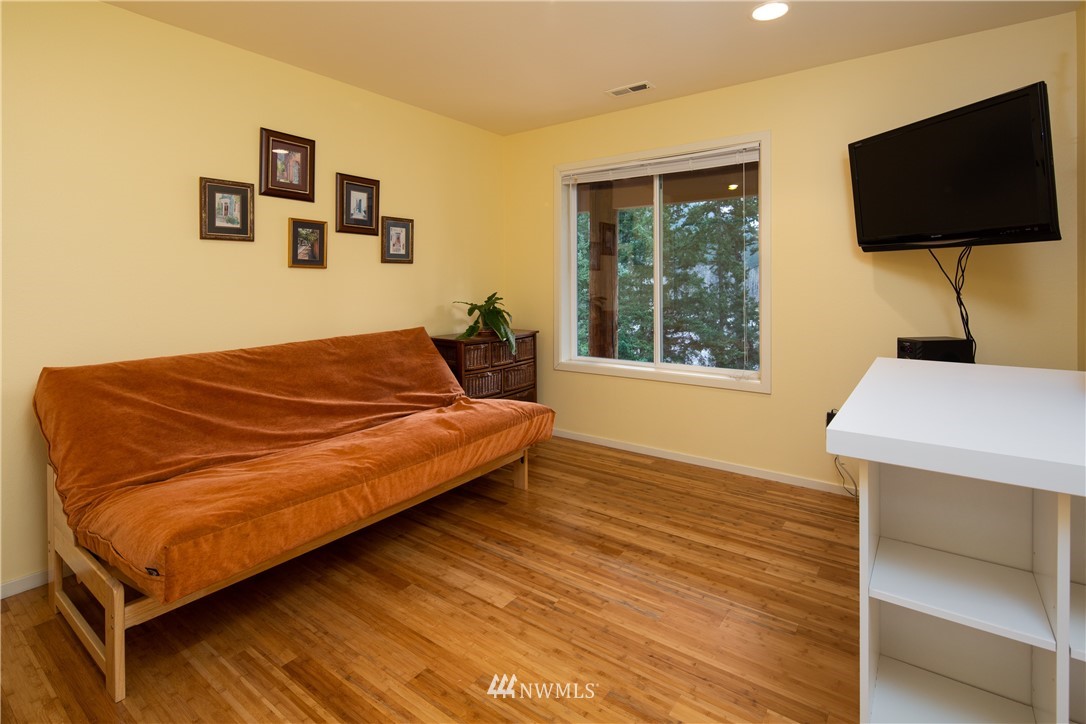 220 Sea Pines Road Bellingham, WA 98229 - Photo 22 of 40 a bedroom with a bed and a flat screen tv