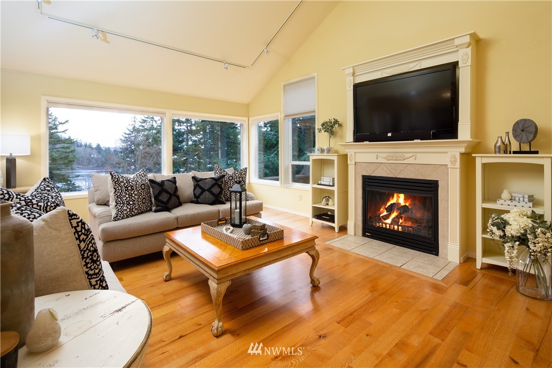 220 Sea Pines Road Bellingham, WA 98229 - Photo 5 of 40 a living room with furniture a flat screen tv and a fireplace