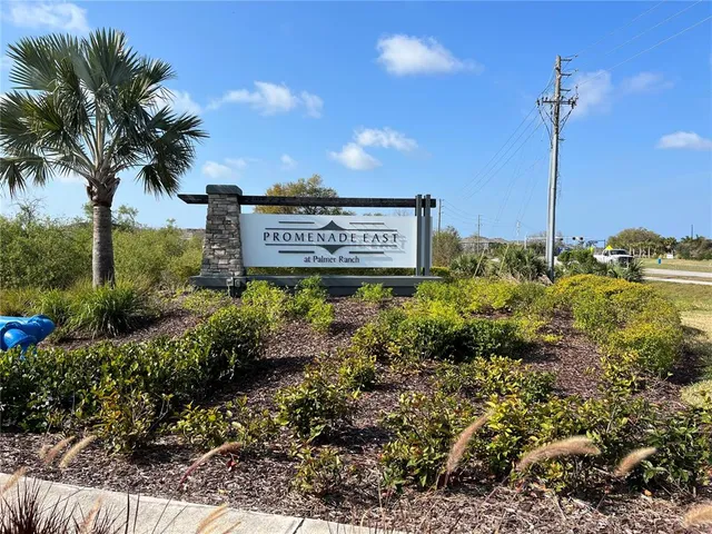 a sign board with tall buildings
