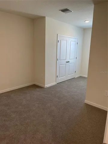 a view of an empty room and closet area