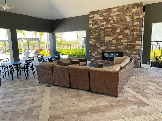a living room with furniture and a floor to ceiling window