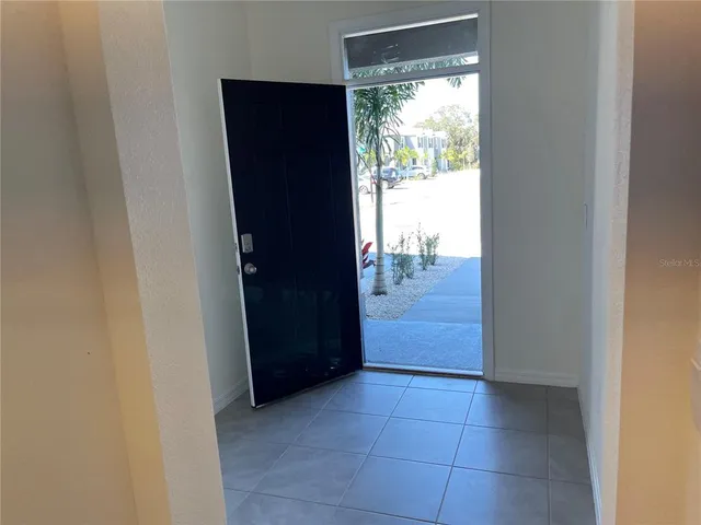 a view of hallway with a bathroom and a sink