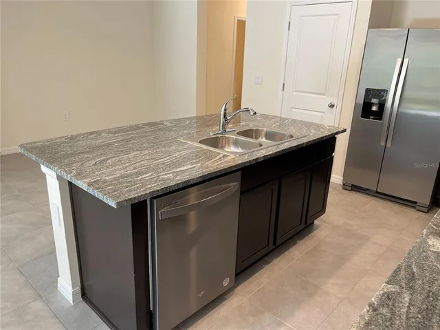 an old kitchen with a sink and a refrigerator