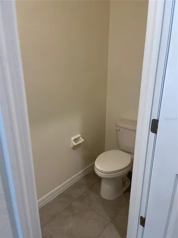 a white toilet sitting next to a sink
