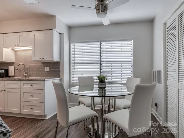 a view of a dining room with furniture and window