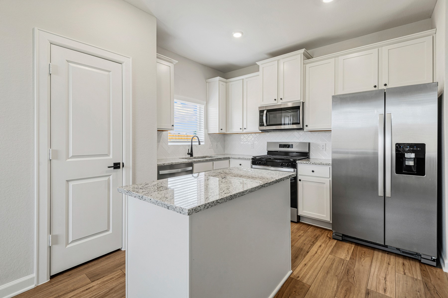 15765 Bayberry Trce Drive Conroe, TX 77303 - Photo 6 of 21 a kitchen with stainless steel appliances granite countertop a refrigerator sink and microwave