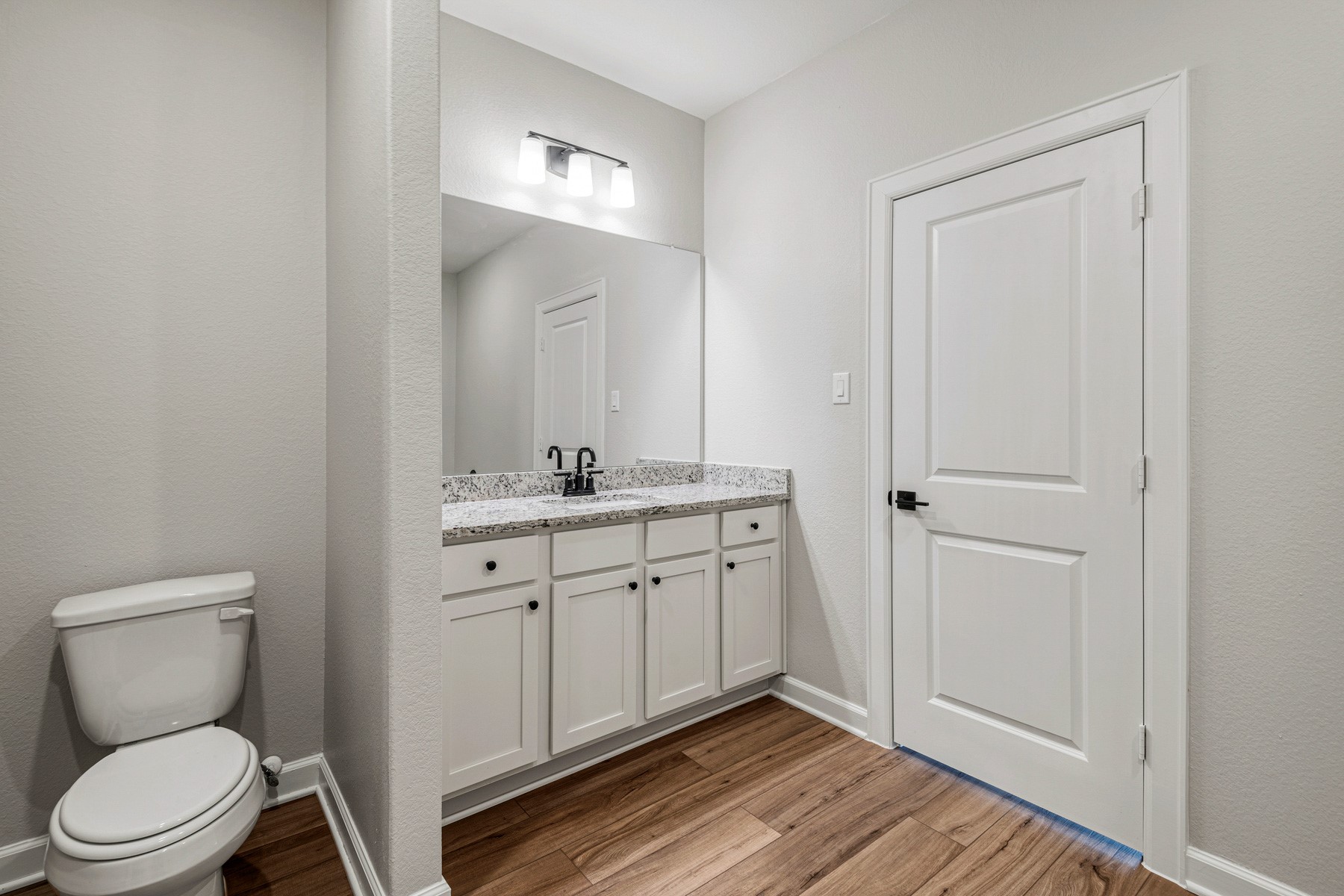 15765 Bayberry Trce Drive Conroe, TX 77303 - Photo 10 of 21 a bathroom with a toilet a sink and mirror