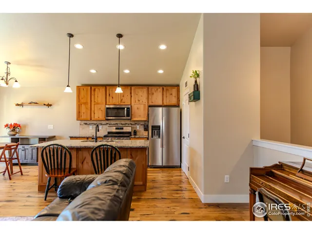 a view of living room kitchen with furniture and wooden floor