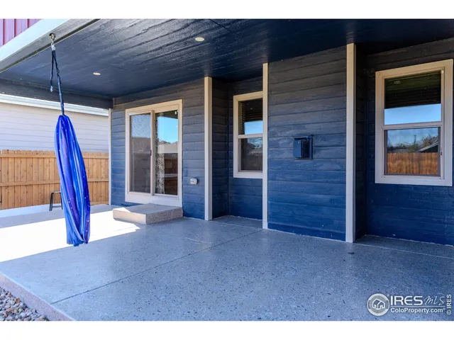 a view of an empty room with furniture and a window