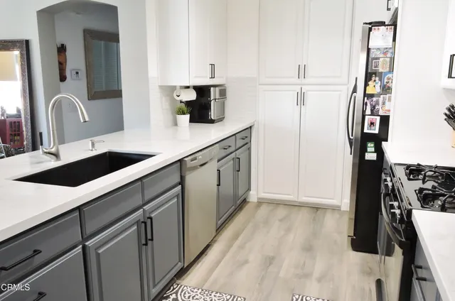 a kitchen with a sink and a refrigerator