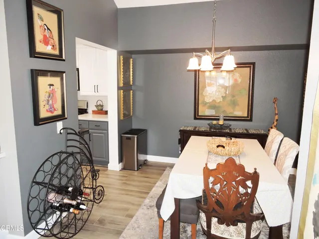 a view of a dining room with furniture and chandelier
