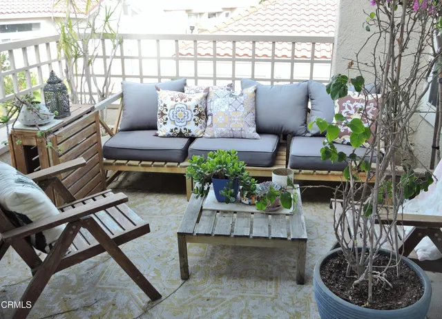 a living room with furniture and a potted plant