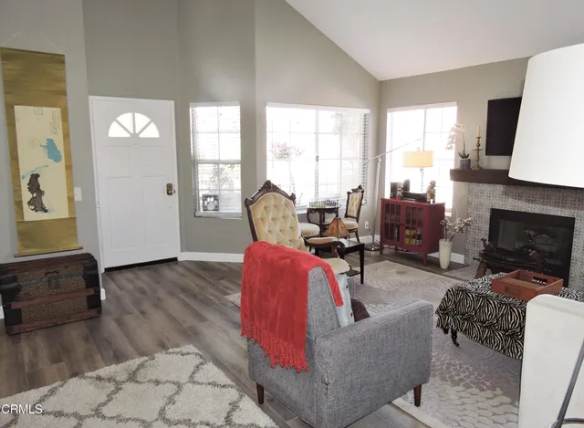 a view of a big house with a big yard and large trees