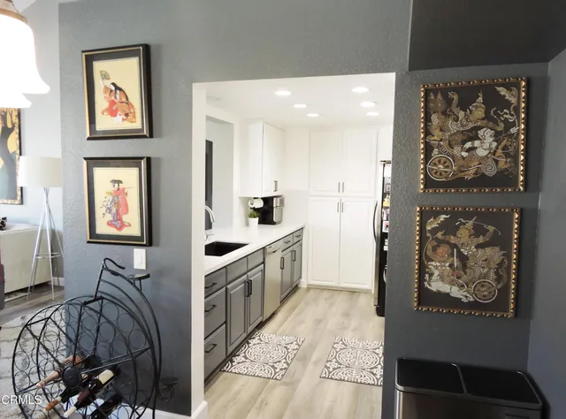 a kitchen with stainless steel appliances granite countertop a refrigerator a stove and a sink