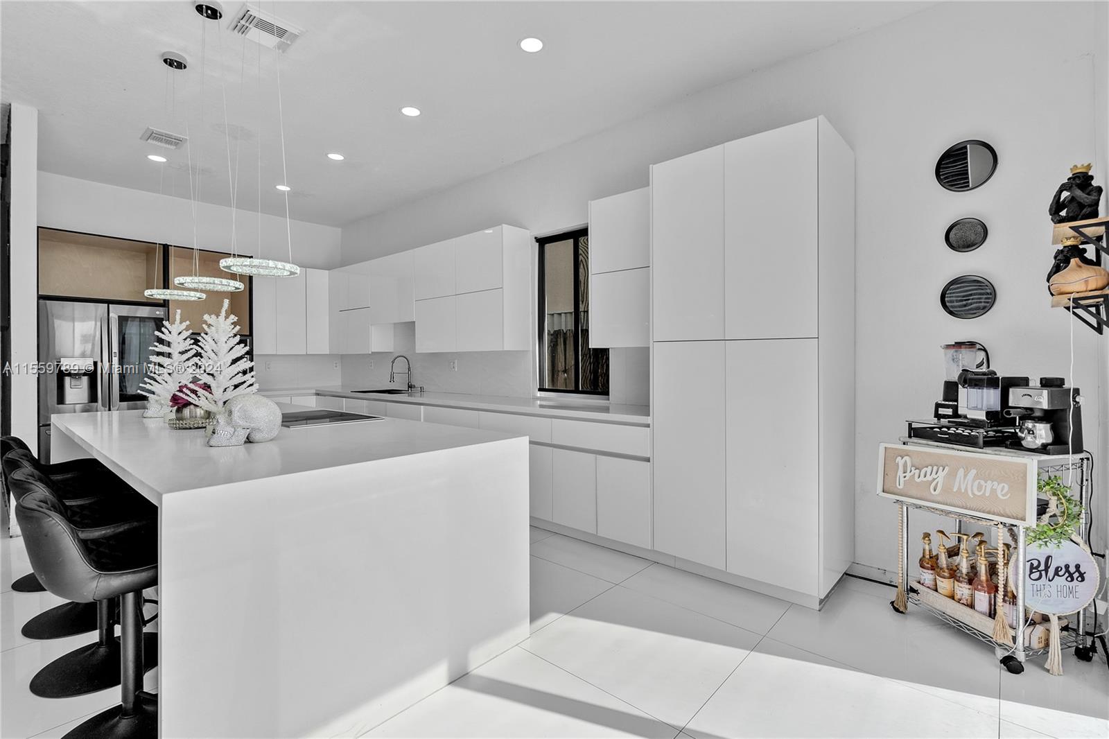 22438 Southwest 94th Path Cutler Bay, FL 33190 - Photo 12 of 38 a kitchen with stainless steel appliances a sink a stove a refrigerator and cabinets