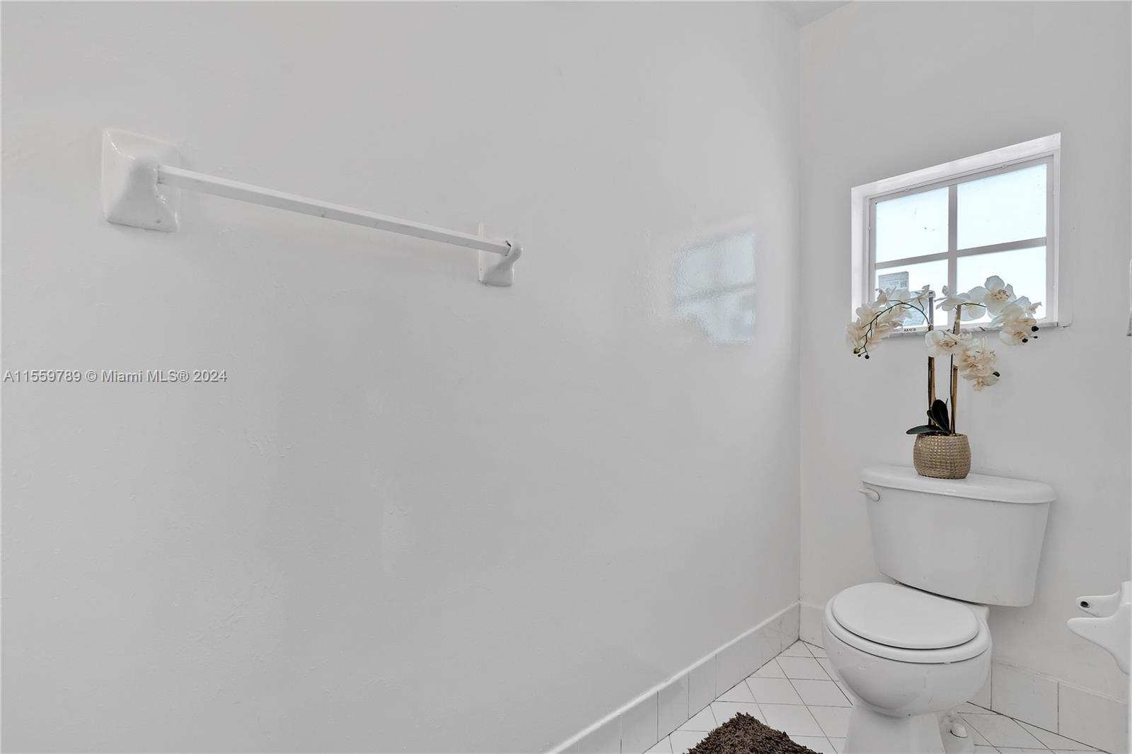 22438 Southwest 94th Path Cutler Bay, FL 33190 - Photo 14 of 38 a white toilet sitting next to a window