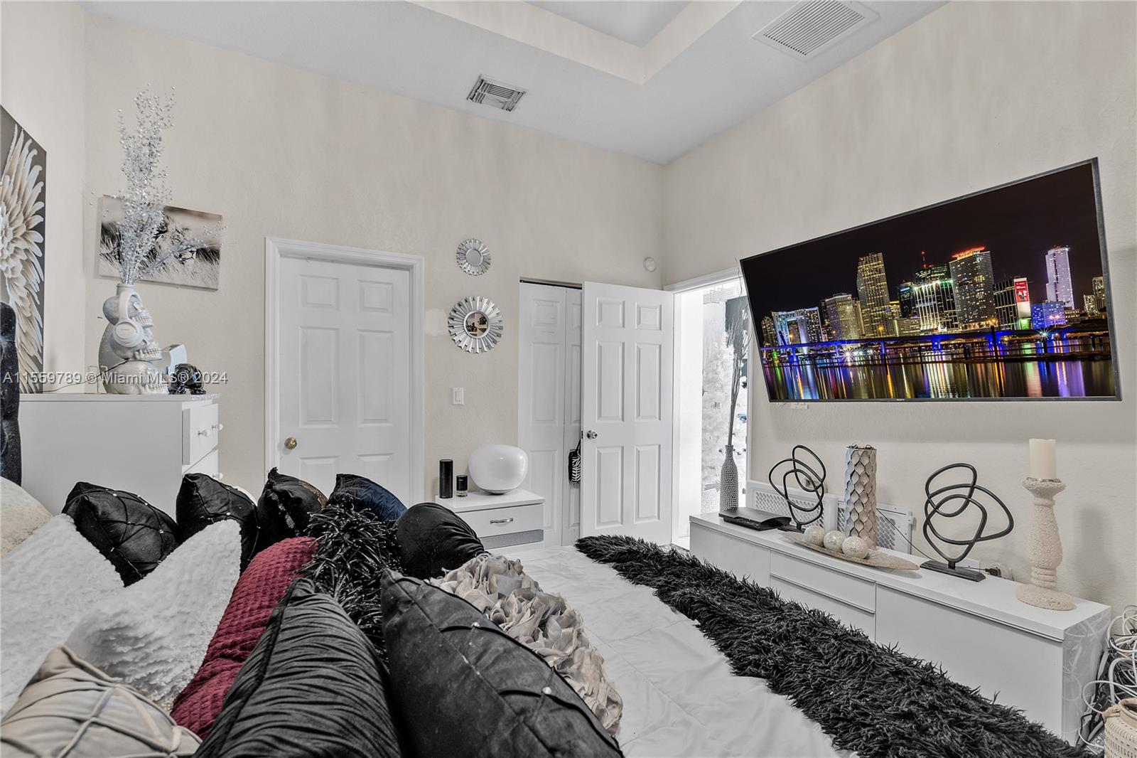 22438 Southwest 94th Path Cutler Bay, FL 33190 - Photo 16 of 38 a bedroom with bed and cabinets