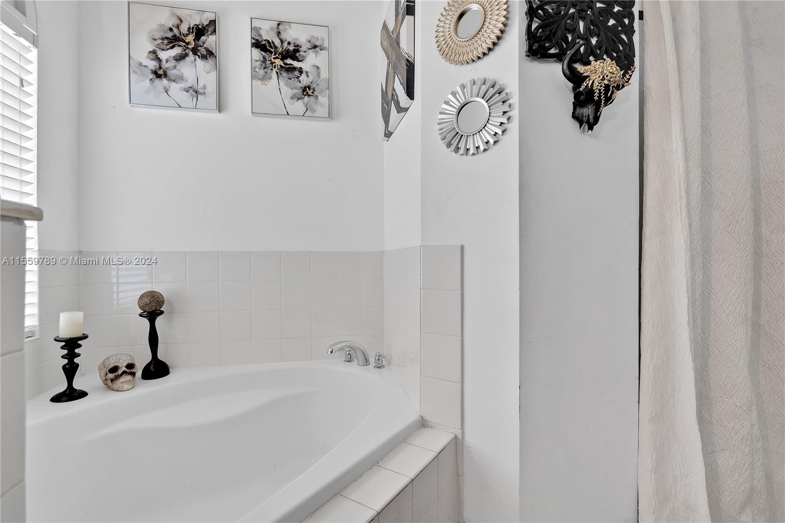 22438 Southwest 94th Path Cutler Bay, FL 33190 - Photo 19 of 38 a bathroom with a bathtub and sink