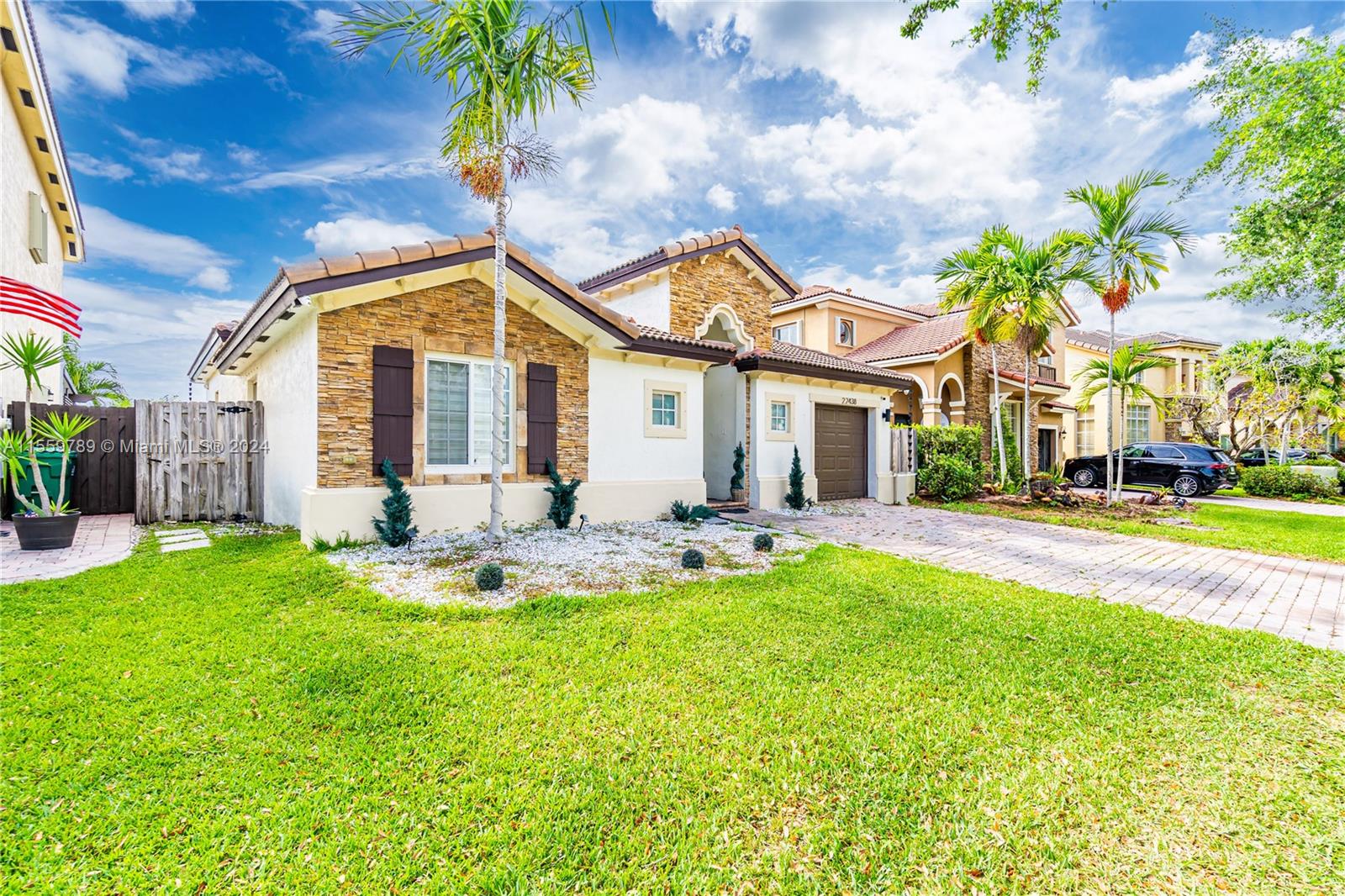 22438 Southwest 94th Path Cutler Bay, FL 33190 - Photo 2 of 38 a front view of a house with swimming pool patio and garden