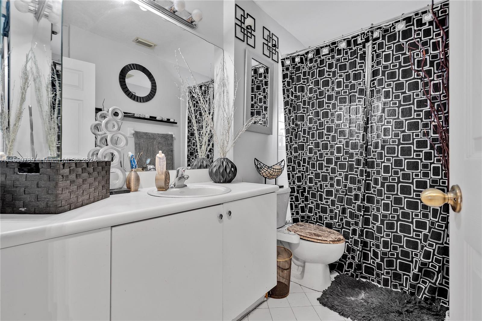22438 Southwest 94th Path Cutler Bay, FL 33190 - Photo 23 of 38 a bathroom with a sink a toilet and a shower