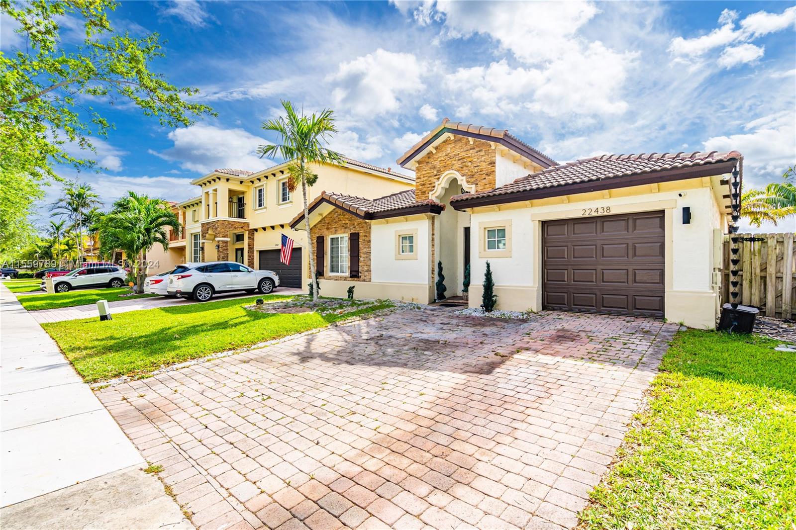 22438 Southwest 94th Path Cutler Bay, FL 33190 - Photo 3 of 38 a front view of a house with a yard and garage