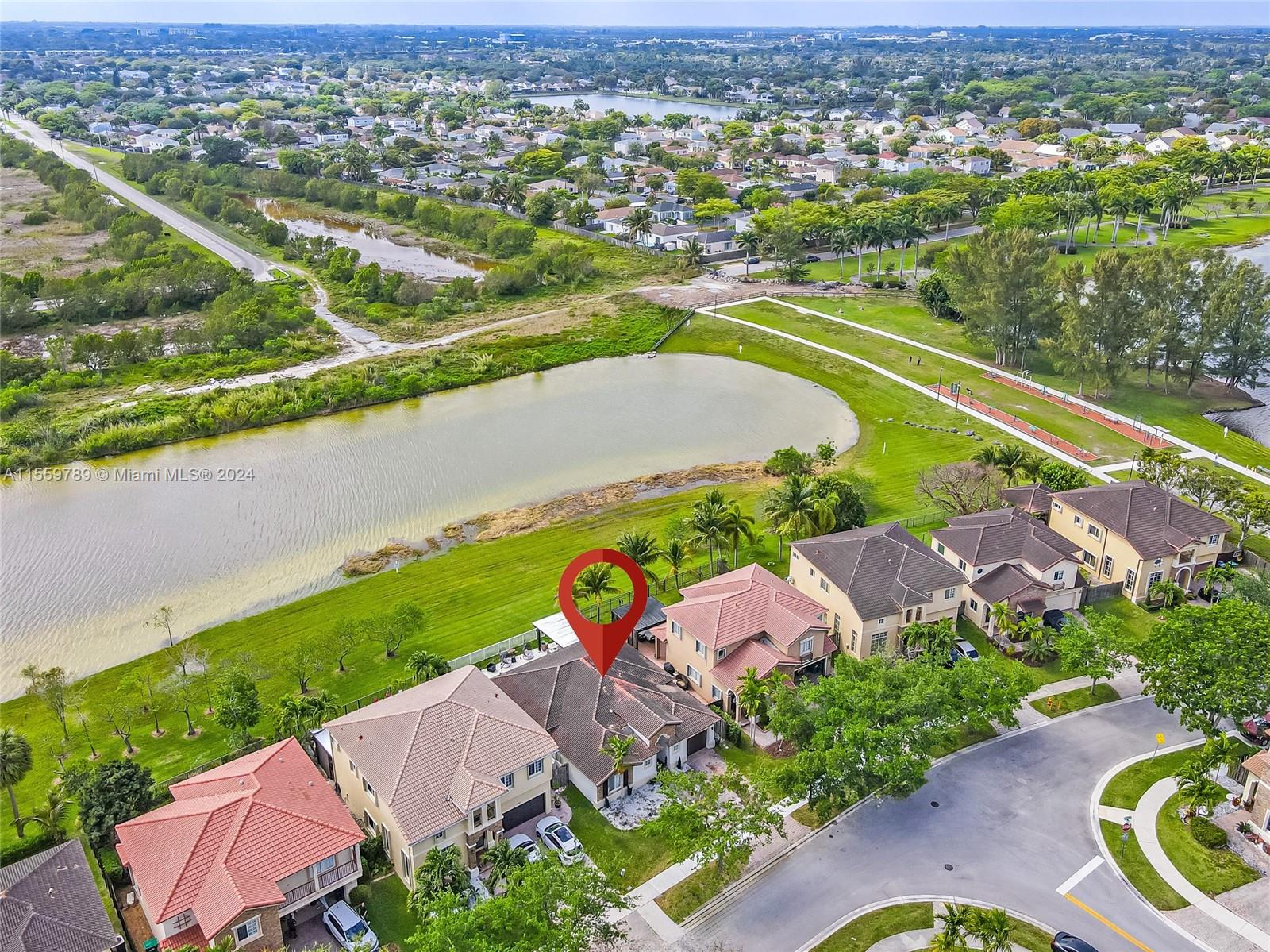 22438 Southwest 94th Path Cutler Bay, FL 33190 - Photo 35 of 38 an aerial view of a house with a swimming pool yard and outdoor seating