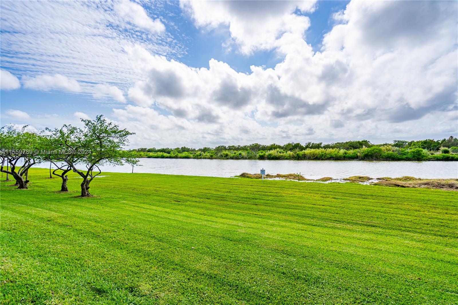 22438 Southwest 94th Path Cutler Bay, FL 33190 - Photo 37 of 38 a view of a lake and a houses