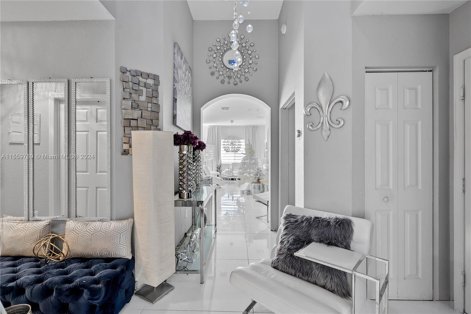 22438 Southwest 94th Path Cutler Bay, FL 33190 - Photo 4 of 38 a living room with furniture and a chandelier
