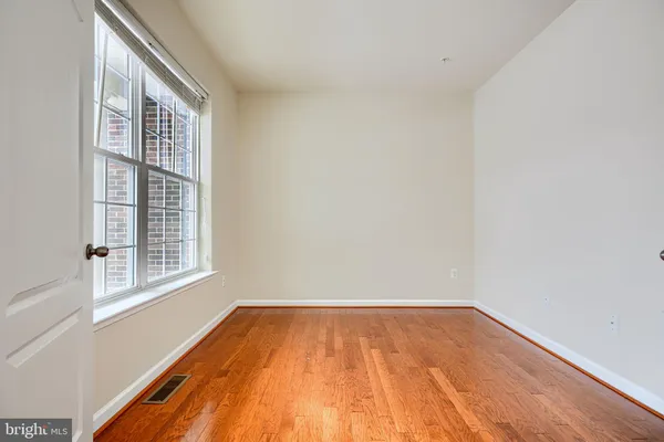 a view of a livingroom with wooden floor and a ceiling fan