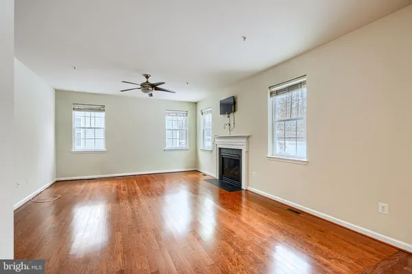 a kitchen with stainless steel appliances granite countertop a stove top oven a sink dishwasher a refrigerator and cabinets with wooden floor