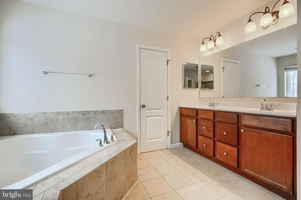 an empty room with closet and a chandelier fan