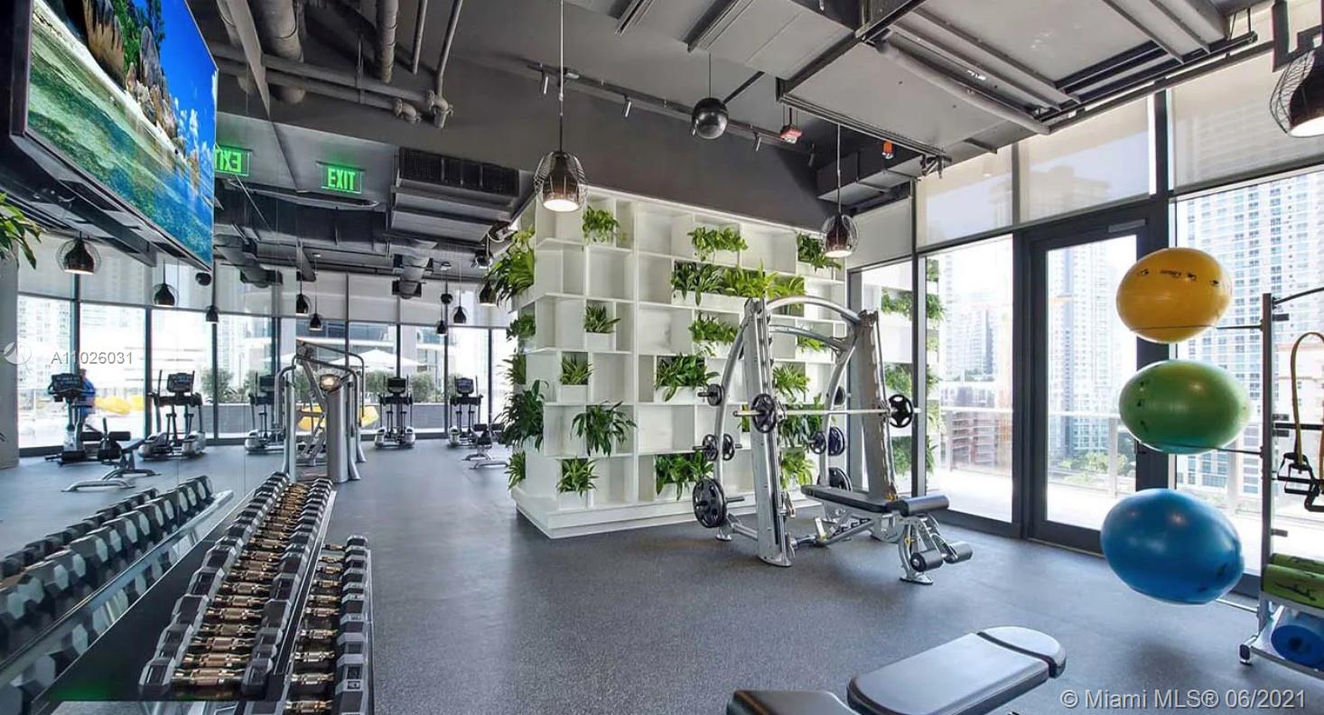 45 Southwest 9th Street, Unit 3102 Miami, FL 33130 - Photo 13 of 19 a gym room with lots of gym equipment