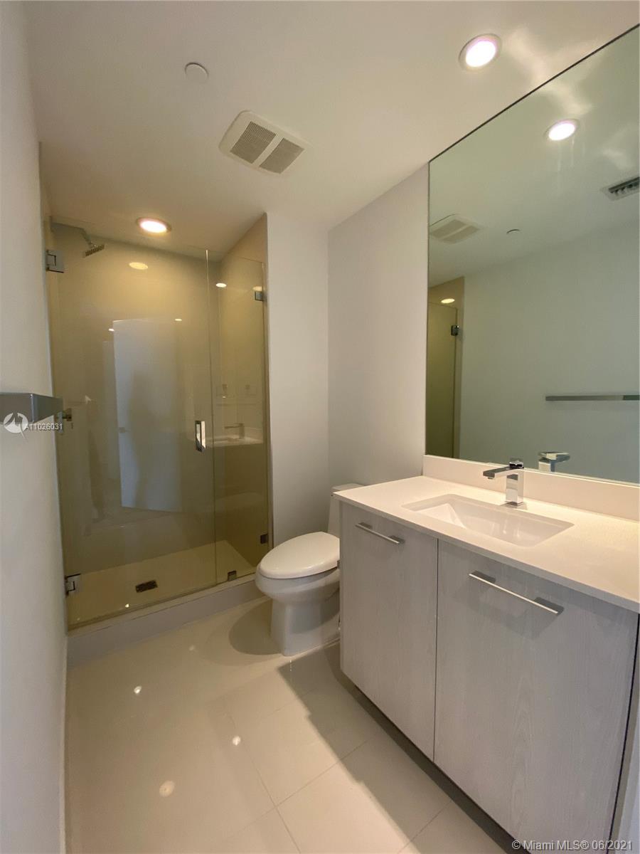 45 Southwest 9th Street, Unit 3102 Miami, FL 33130 - Photo 3 of 19 a spacious bathroom with a granite countertop sink a toilet and shower