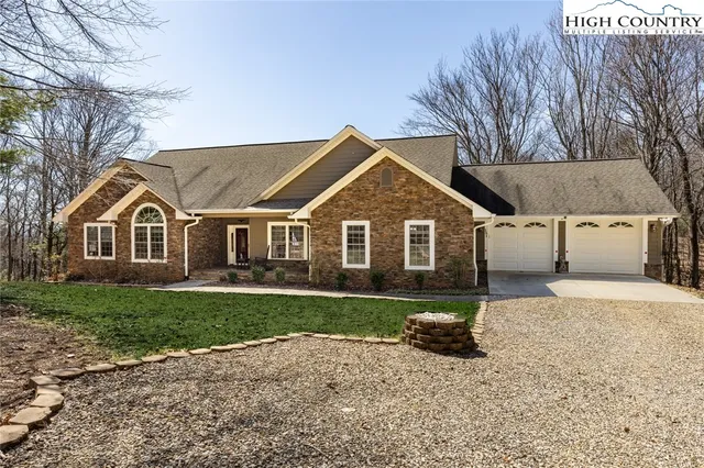 a view of a yard in front of a house with large trees