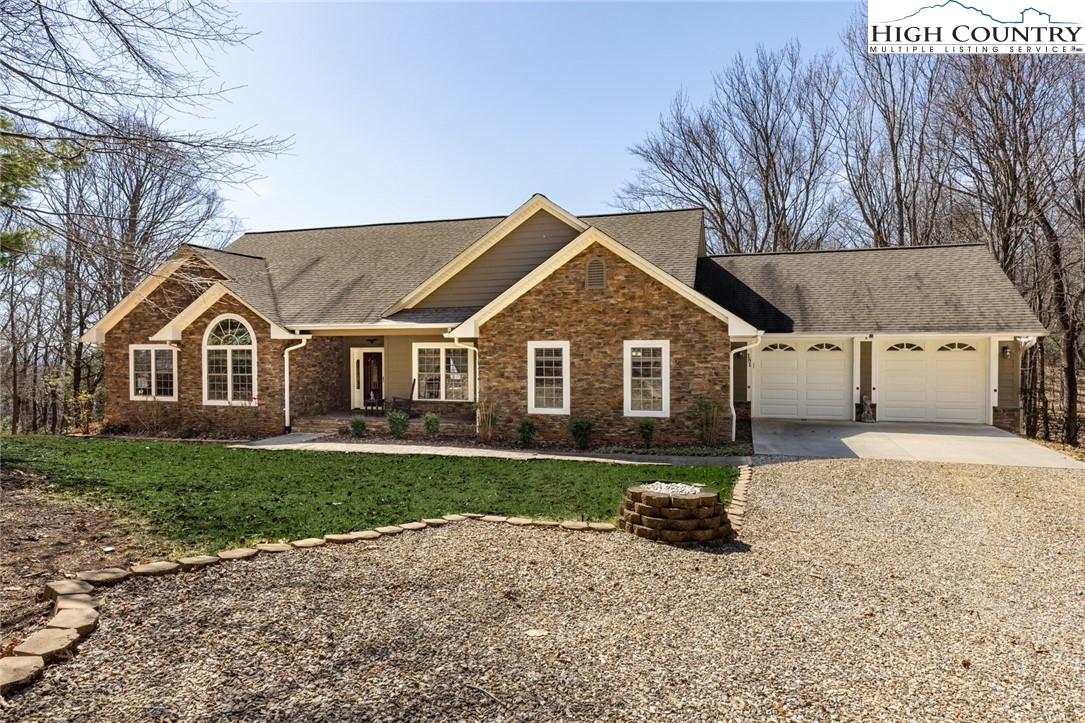 a view of a yard in front of a house with large trees