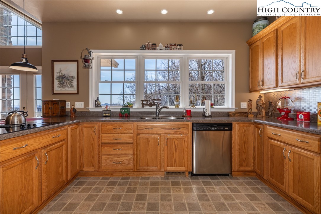 181 Abbey Road McGrady, NC 28649 - Photo 19 of 50 a kitchen with stainless steel appliances a sink window and cabinets