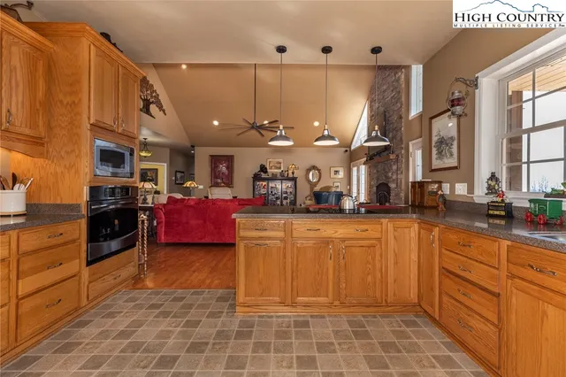 a kitchen with stainless steel appliances granite countertop a refrigerator a oven a sink and dishwasher
