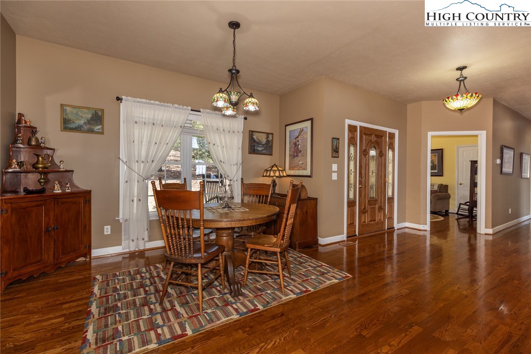 181 Abbey Road McGrady, NC 28649 - Photo 22 of 50 a view of a dining room with furniture and wooden floor