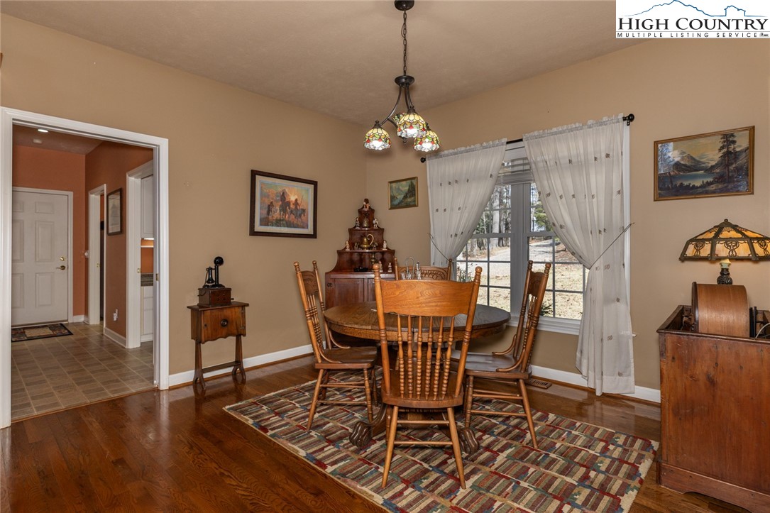 181 Abbey Road McGrady, NC 28649 - Photo 23 of 50 a view of a dining room with furniture and wooden floor