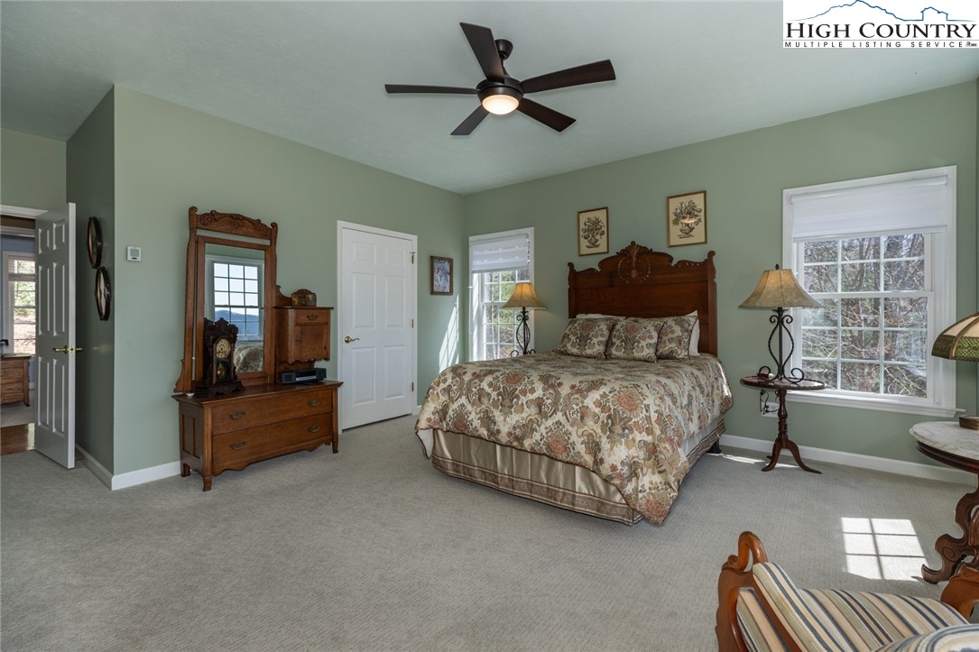 181 Abbey Road McGrady, NC 28649 - Photo 26 of 50 a bedroom with a bed and a chandelier