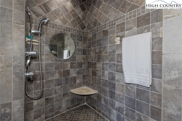 a bathroom with a tub sink and mirror