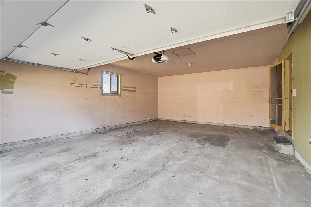 1087 Fairfield Road Troy, OH 45373 - Photo 32 of 39 This spacious garage offers ample room for vehicles and storage, featuring durable concrete flooring.