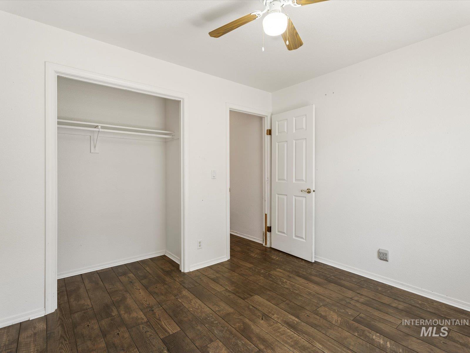 3540 Wills Road Emmett, ID 83617 - Photo 21 of 36 Room featuring wood-finish flooring, a ceiling fan with light fixture, and a white paneled door