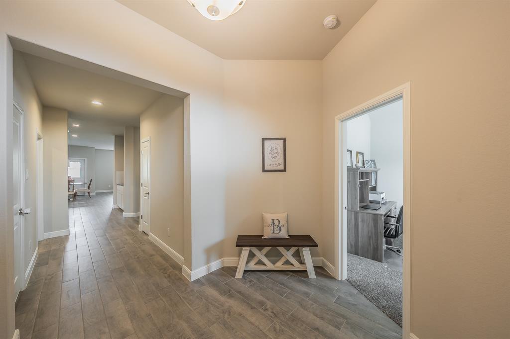 1212 Bosque Lane Weatherford, TX 76087 - Photo 3 of 38 a view of a hallway and dining room with wooden floor