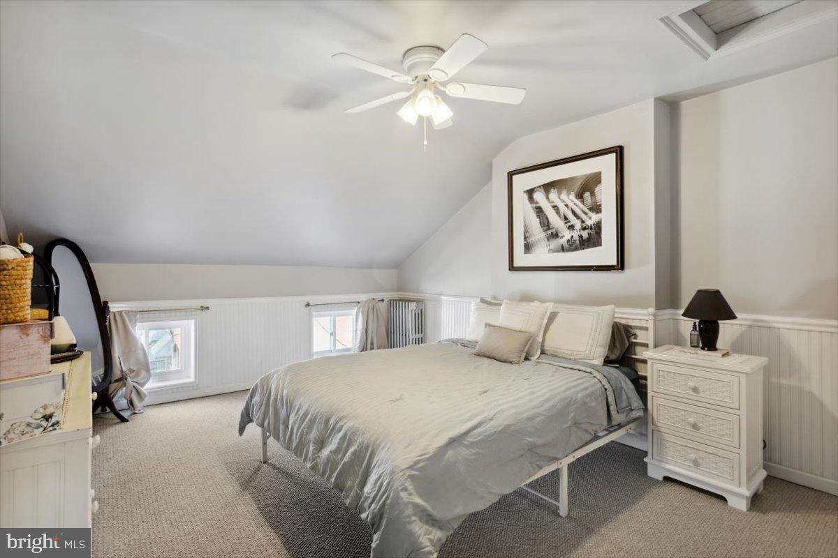 214 Ripka Street Philadelphia, PA 19127 - Photo 11 of 15 a bedroom with a large bed and a chandelier