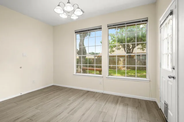 a kitchen with granite countertop a refrigerator and a stove top oven