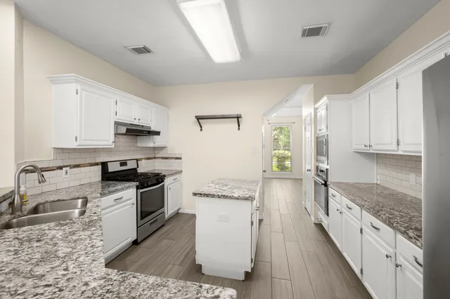 a kitchen with a stove sink and refrigerator