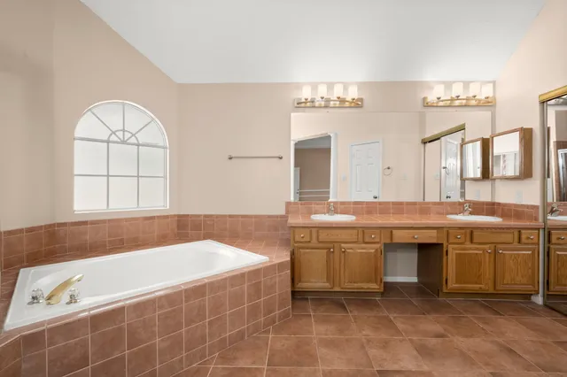a bathroom with a tub sink and shower