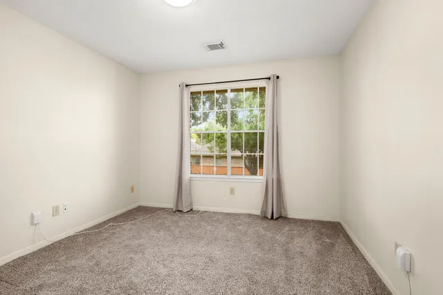 a bathroom with a granite countertop tub sink and mirror