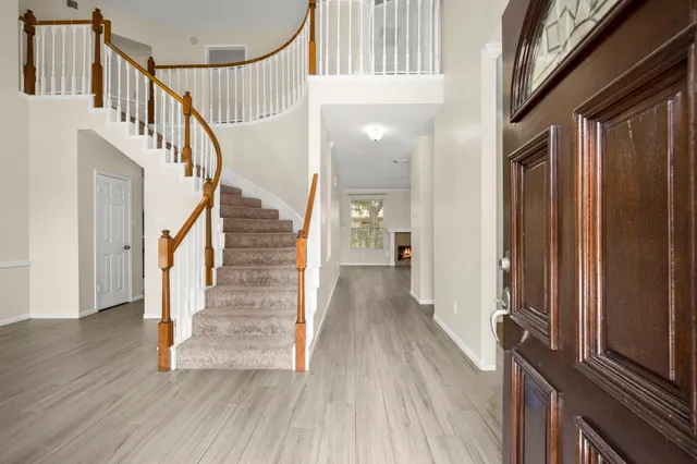 a view of an entryway with wooden floor and door